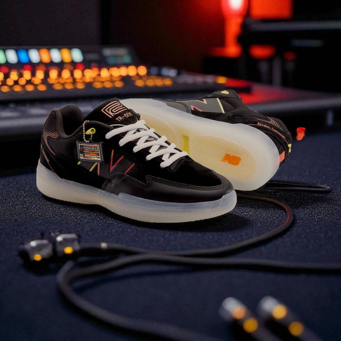 New Balance Numeric 808 Lite x Roland TR-808 sneaker in black suede with translucent sole, photographed in a music studio with synth cables and warm lighting.