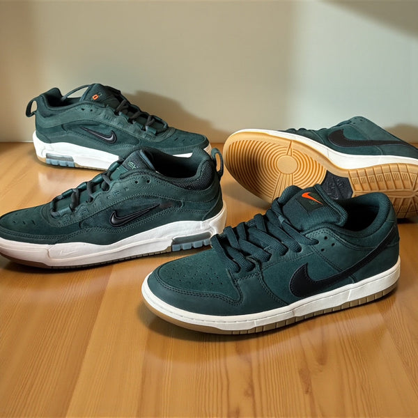 An image of the final 2 pairs of the Nike SB Orange Label collection placed on a wooden floor top 